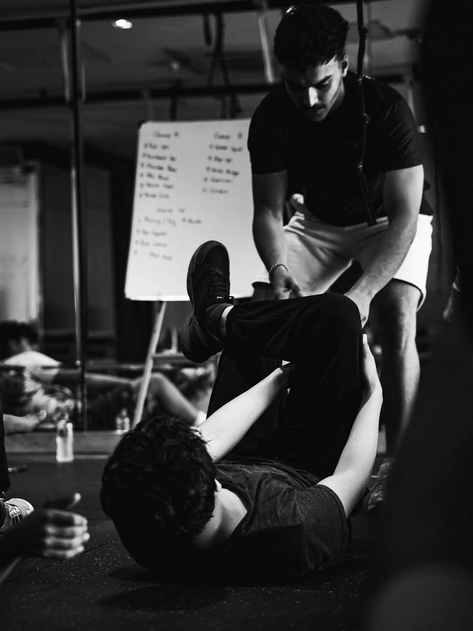 A coach supports a participant and corrects his position during training