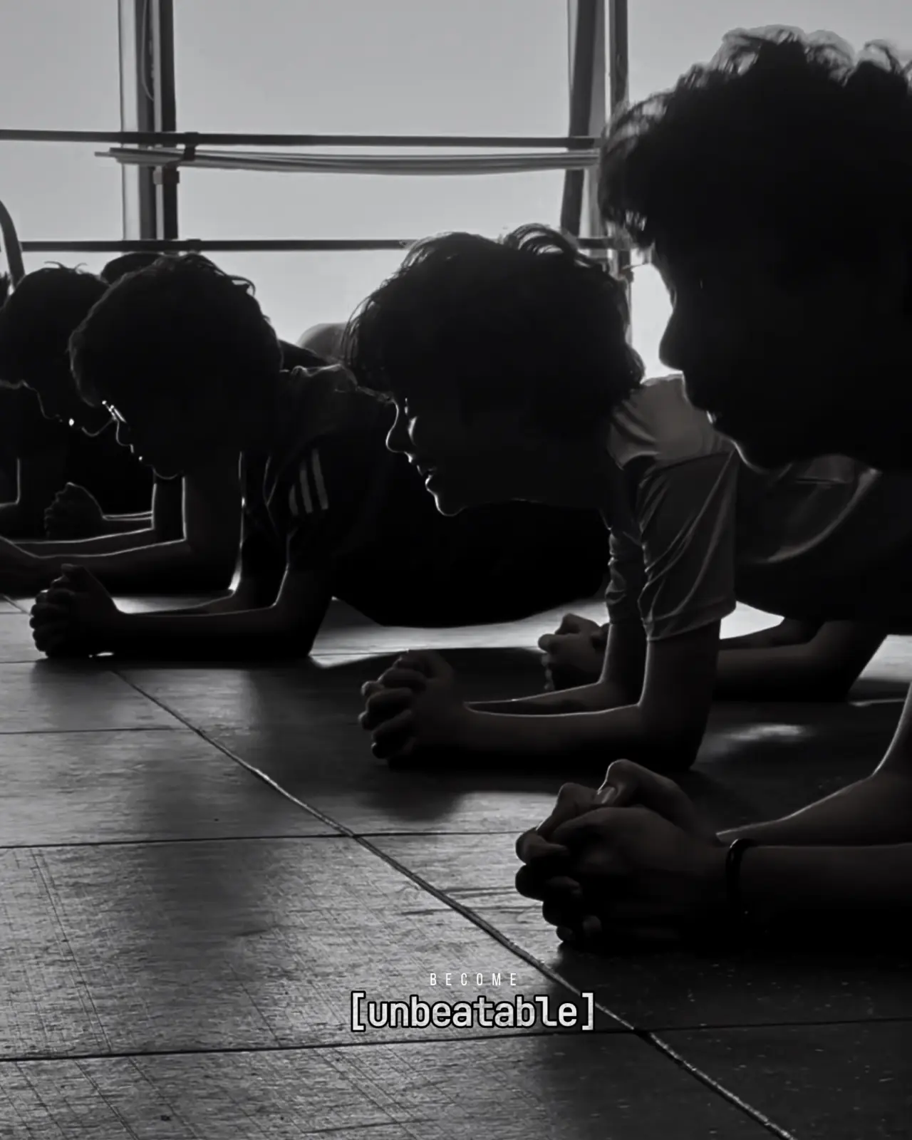 A line of participants holds a plank together during conditioning