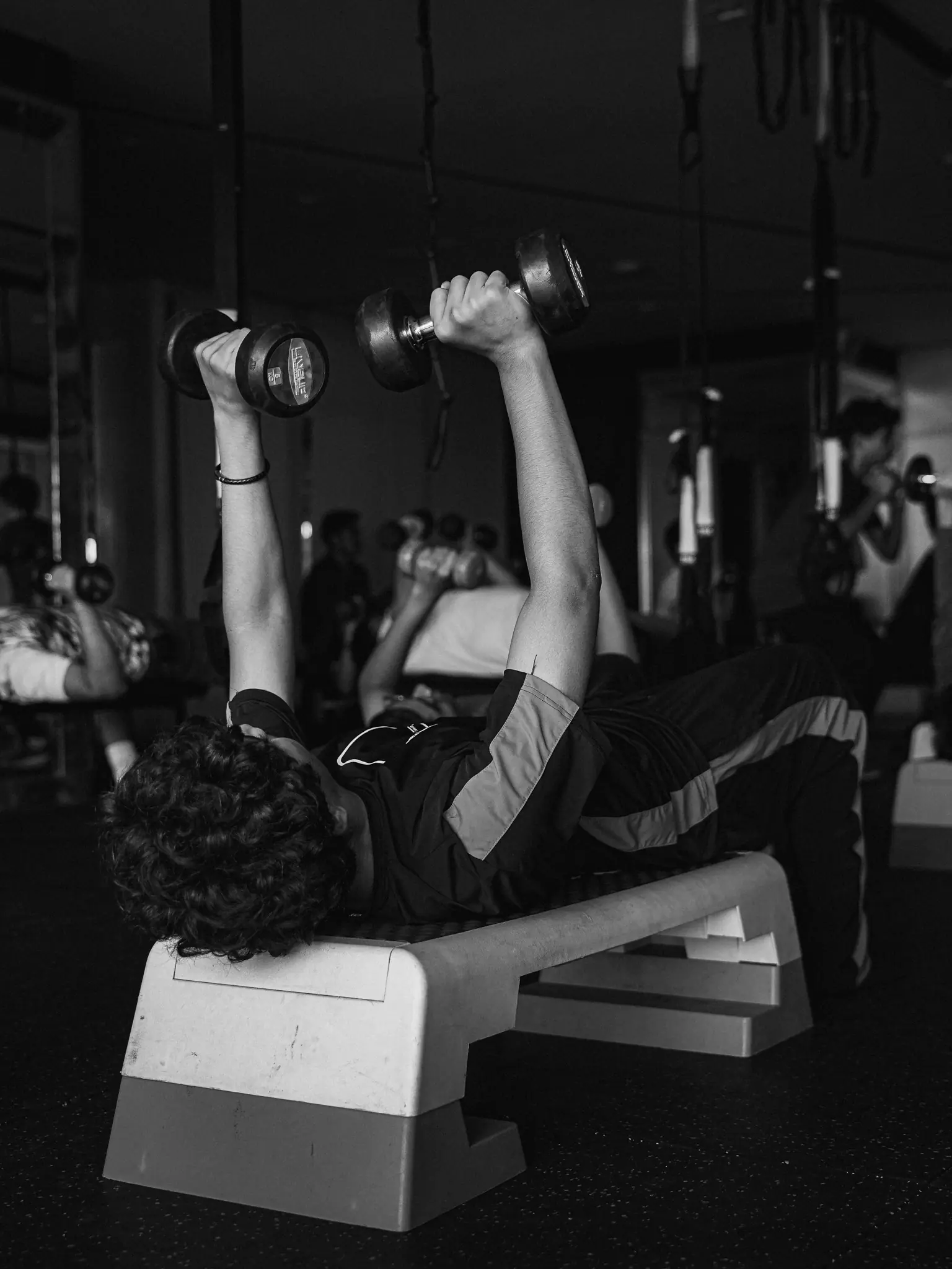 A participant performs a controlled dumbbell press
