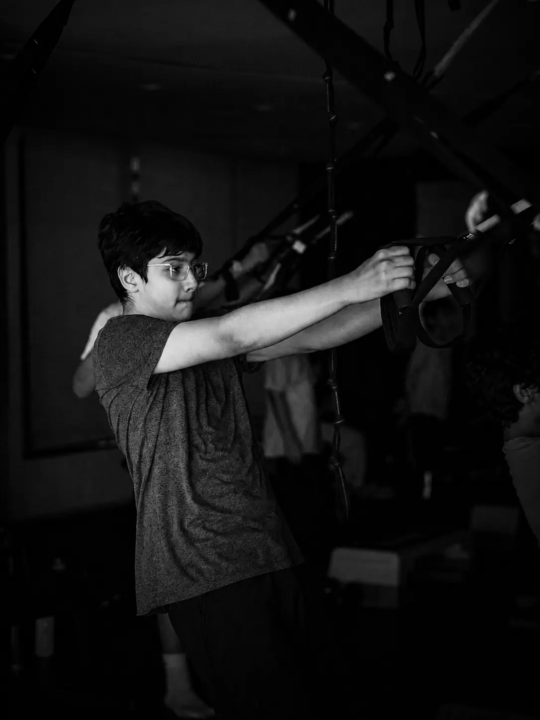 A participant building strength with suspension straps